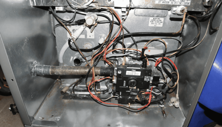 Close-up of a furnace interior showing detailed wiring and components, including the pressure switch. This image highlights key areas for diagnosing and fixing common furnace issues such as pressure switch failures.