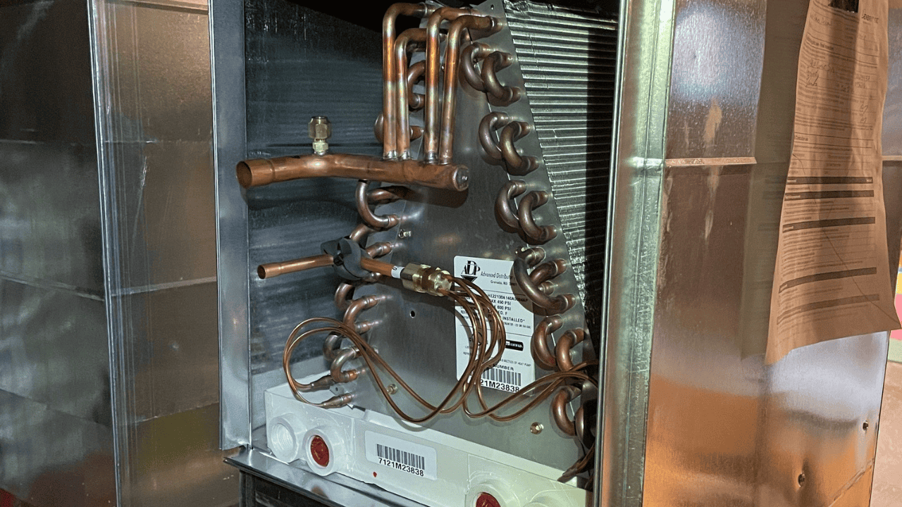 A close-up of an open furnace component showing detailed wiring connected to the pressure switch, highlighting areas for troubleshooting common furnace pressure switch problems.
